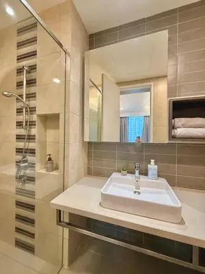 a bathroom with a sink and a shower and a mirror at Robertson Homefeel 1R1B at Bukit Bintang KL KLCC in Kuala Lumpur