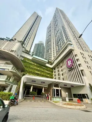 a building with green plants on it with tall buildings at Robertson Homefeel 1R1B at Bukit Bintang KL KLCC in Kuala Lumpur