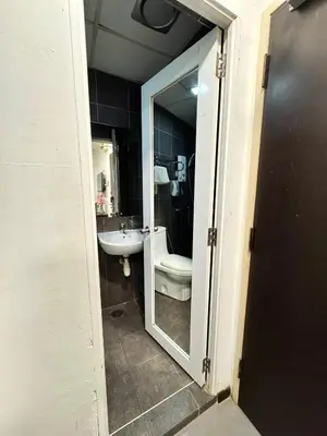 a bathroom with a toilet and a sink at Swiss Hotel at City Centre in Kuala Lumpur