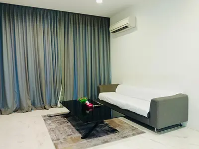 a bedroom with a bed and a curtain at The Platinum Suite KL in Kuala Lumpur