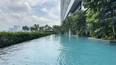 a pool of blue water next to a building at Couple 1BR cozy suite B41 05 Trion KL in Kuala Lumpur
