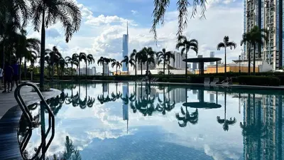a pool of water with palm trees and a building at Couple nest A37 10St Trion KL in Kuala Lumpur