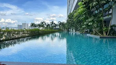 a large pool of blue water next to a building at Couple nest A37 10St Trion KL in Kuala Lumpur