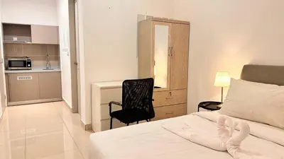 a bedroom with a bed and a chair next to a desk at Couple Private studio B22 11 Trion KL in Kuala Lumpur