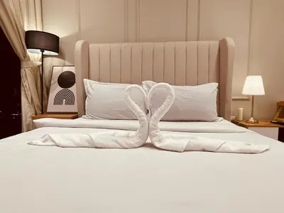 a white bed with two white towels on it at Couple studio A21 09 Netflix Trion KL in Kuala Lumpur