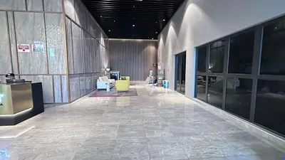a lobby with a yellow chair in a building at Couple studio A21 09 Netflix Trion KL in Kuala Lumpur