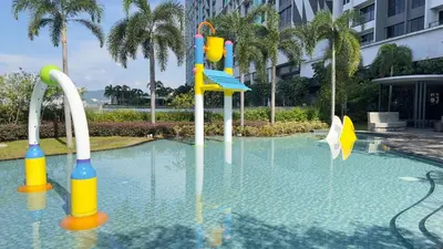 a swimming pool with a playground in the water at Couple Studio Suite A16 07 Trion KL in Kuala Lumpur
