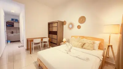 a bedroom with a bed and a table in it at Couple Studio Suite B29 03A Trion KL in Kuala Lumpur