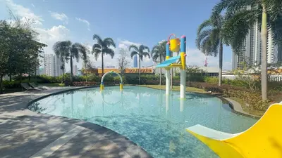 a swimming pool with a slide in a resort at Couple Studio Suite B29 03A Trion KL in Kuala Lumpur