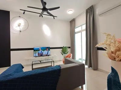 a living room with a blue couch and a tv at O 3 Room 200mbps wifi near Mrt Lrt HKL PWTC KLCC in Kuala Lumpur