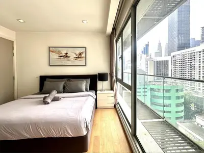 a bedroom with a bed and a large window at Bintang Fairlane Residence, KLCC & City View with Bathtub - 2B1R in Kuala Lumpur