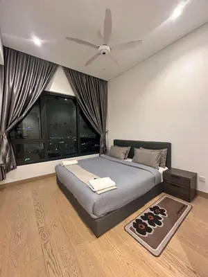 a bedroom with a bed with a ceiling fan at Lucentia Residences By CasaLuxe in Kuala Lumpur