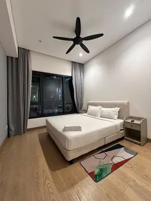 a bedroom with a bed and a ceiling fan at Lucentia Residences By CasaLuxe in Kuala Lumpur