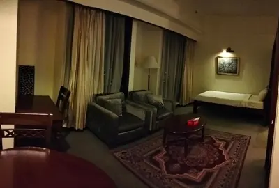 a living room with a couch and a bed at Times Apartment at Times Square in Kuala Lumpur