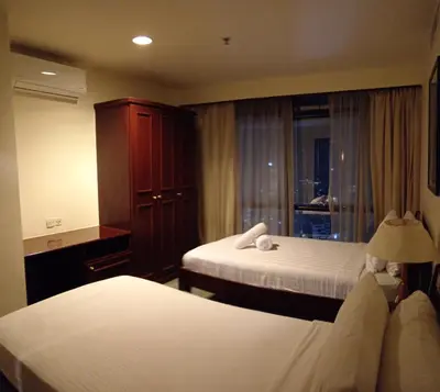 a hotel room with two beds and a window at Times Apartment at Times Square in Kuala Lumpur