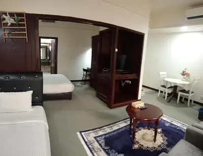 a hotel room with a bed and a couch and a table at Times Apartment at Times Square in Kuala Lumpur