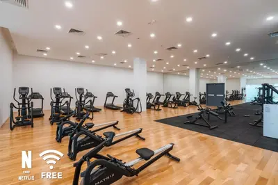 a gym with treadmills and elliptical machines at Gleneagles Hospital - 3BR with Pool & Near KLCC in Kuala Lumpur