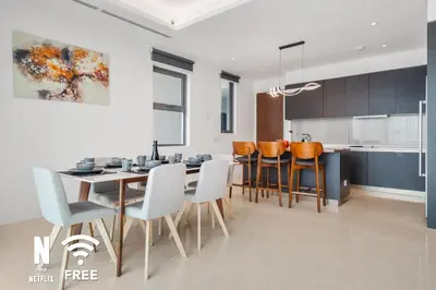 a kitchen and dining room with a table and chairs at Gleneagles Hospital - 3BR with Pool & Near KLCC in Kuala Lumpur