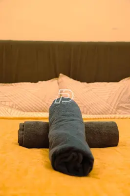 a persons leg laying on a bed with a sock at KL Hartamas 1BR, Mall Link, Wifi Smart TV in Kuala Lumpur