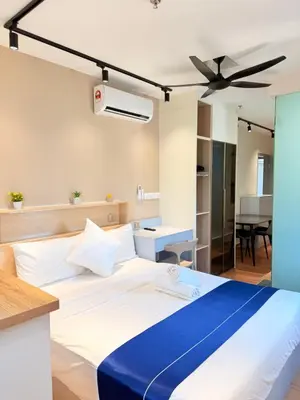 a bedroom with a large bed with a ceiling fan at The Sentral Nook KL Sentral By Riveria city in Kuala Lumpur