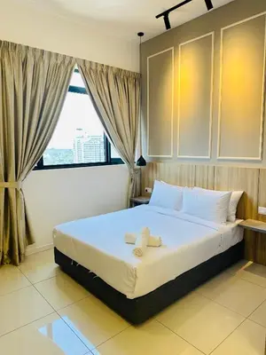 a bedroom with a bed with two towels on it at Chamber Haven KL in Kuala Lumpur
