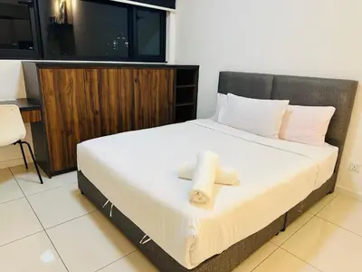a bedroom with a bed with two towels on it at Chamber Haven KL in Kuala Lumpur