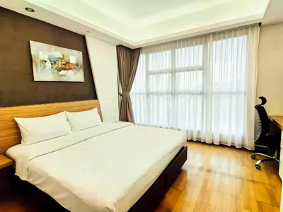 a bedroom with a large bed and a window at Suasana Suites by Lisa in Kuala Lumpur