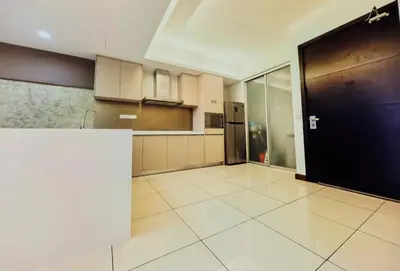 a large kitchen with a black door in a room at Suasana Suites by Lisa in Kuala Lumpur