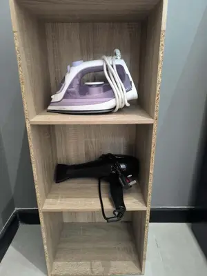 a telephone and a corded handset in a cabinet at Neu Suites in Kuala Lumpur