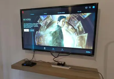 a flat screen tv hanging on a wall at Neu Suites in Kuala Lumpur
