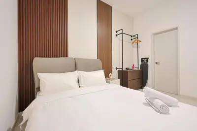 a bedroom with a large white bed with white pillows at Majestic Residence Home Plus in Kuala Lumpur