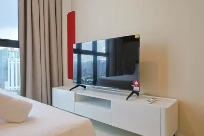 a living room with a large tv on a wall at Majestic Residence Home Plus in Kuala Lumpur