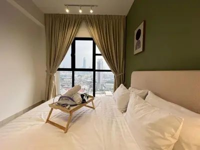 a bedroom with a white bed with a window at Trion KL By AlwaysHome in Kuala Lumpur