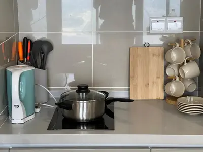 a pot on top of a stove in a kitchen at Trion KL By AlwaysHome in Kuala Lumpur