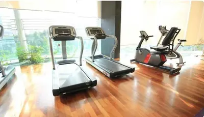 three exercise bikes in a gym with a wooden floor at 0710 Sweet Home-Casa Residency 2R 2B in Kuala Lumpur