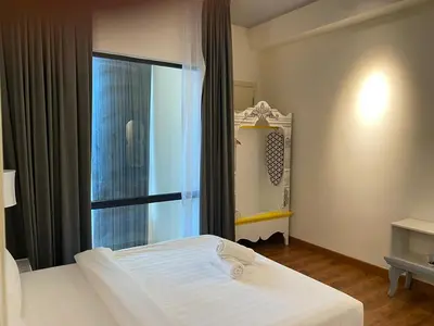 a bedroom with a white bed and a window at Stylish 2 bedroom duplex bedroom city center in Kuala Lumpur