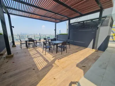 a patio with tables and chairs on top of a building at Compact Studio Near Gleneagles KLCC in Kuala Lumpur