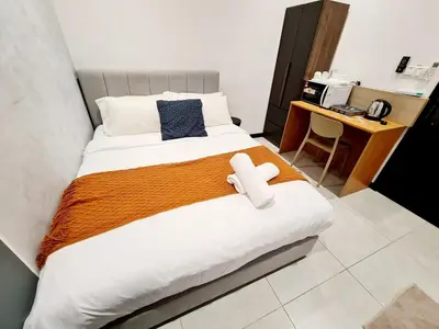 a bedroom with a bed with a teddy bear on it at Neu Suites Tiny Queen Bed Studio 10 mins to KLCC in Kuala Lumpur