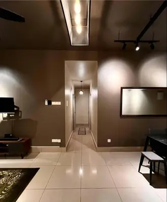 a large room with a hallway with a blank screen on the wall at Raay Home at Razak City Residence KL in Kuala Lumpur