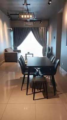a dining room with a table and chairs and a couch at Raay Home at Razak City Residence KL in Kuala Lumpur