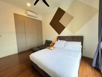 a bedroom with a large bed and a chair at UNA Residensi Jln Peel Fully Air Con Homestay in Kuala Lumpur