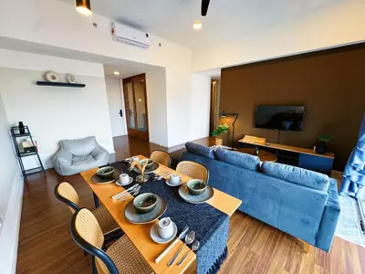 a living room with a blue couch and a table at UNA Residensi Jln Peel Fully Air Con Homestay in Kuala Lumpur