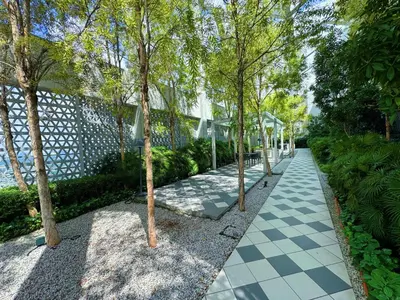 a walkway with trees and a building at UNA Residensi Jln Peel Fully Air Con Homestay in Kuala Lumpur