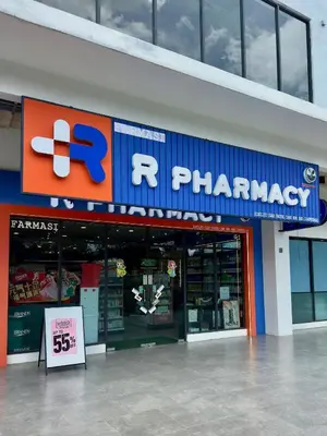a store with a pharmacy sign in front of it at Near in Kuala Lumpur