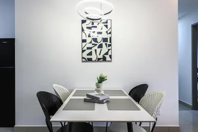 a dining room with a white table and chairs at M Vertica Home Plus in Kuala Lumpur