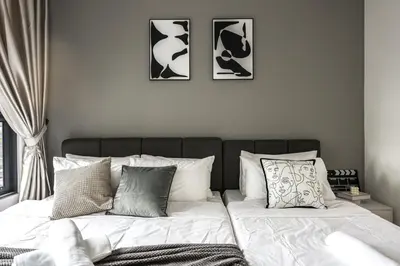 a bedroom with a bed with three pictures on the wall at M Vertica Home Plus in Kuala Lumpur