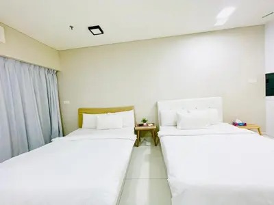 two beds in a room with white walls at Luxury Mercu Summer Suites KLCC By Majestic in Kuala Lumpur