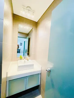 a bathroom with a sink and a mirror at Luxury Mercu Summer Suites KLCC By Majestic in Kuala Lumpur