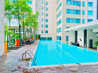 a swimming pool in front of a building at Luxury Mercu Summer Suites KLCC By Majestic in Kuala Lumpur