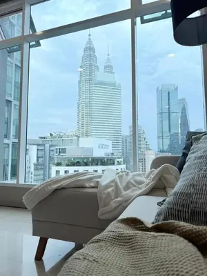 a bedroom with a view of a city from a window at Soho Suites KLCC by City Keys in Kuala Lumpur